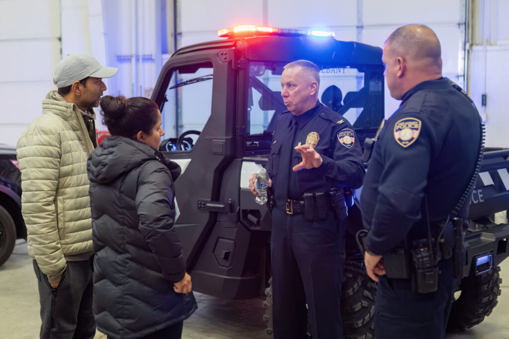 two police officers talking with people in the community