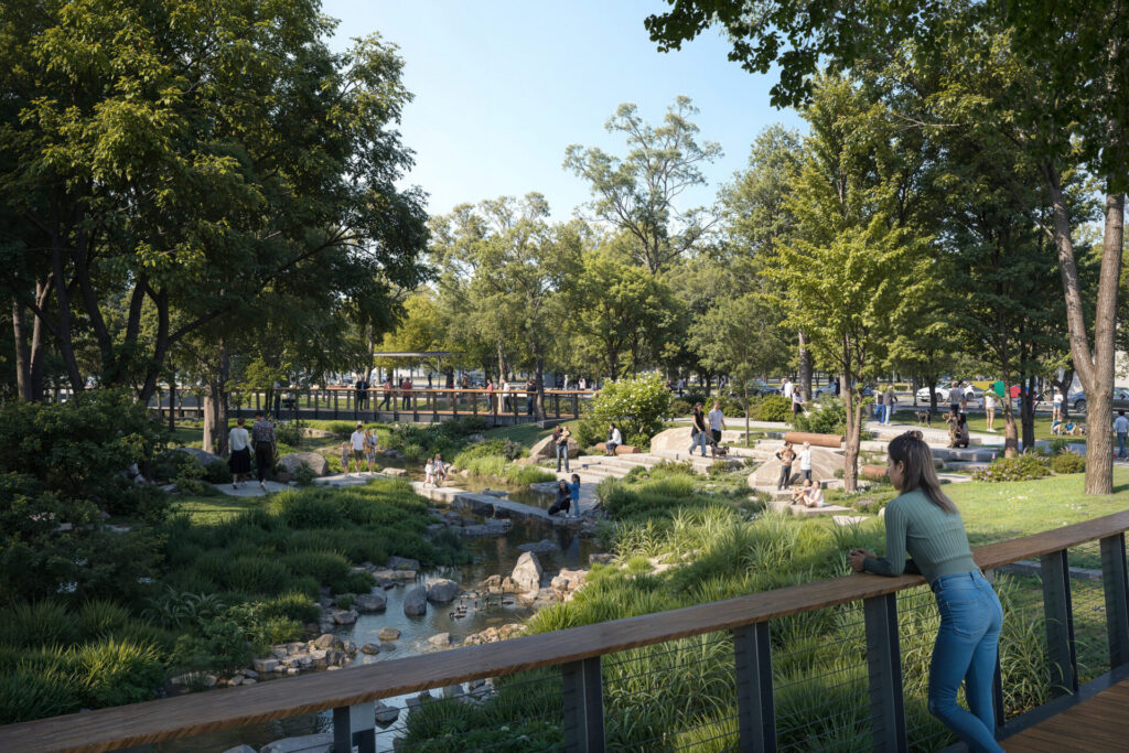 Woman in a green top leaning on a wooden railing overlooking a leafy park with a stream, rocks, and people walking and sitting.