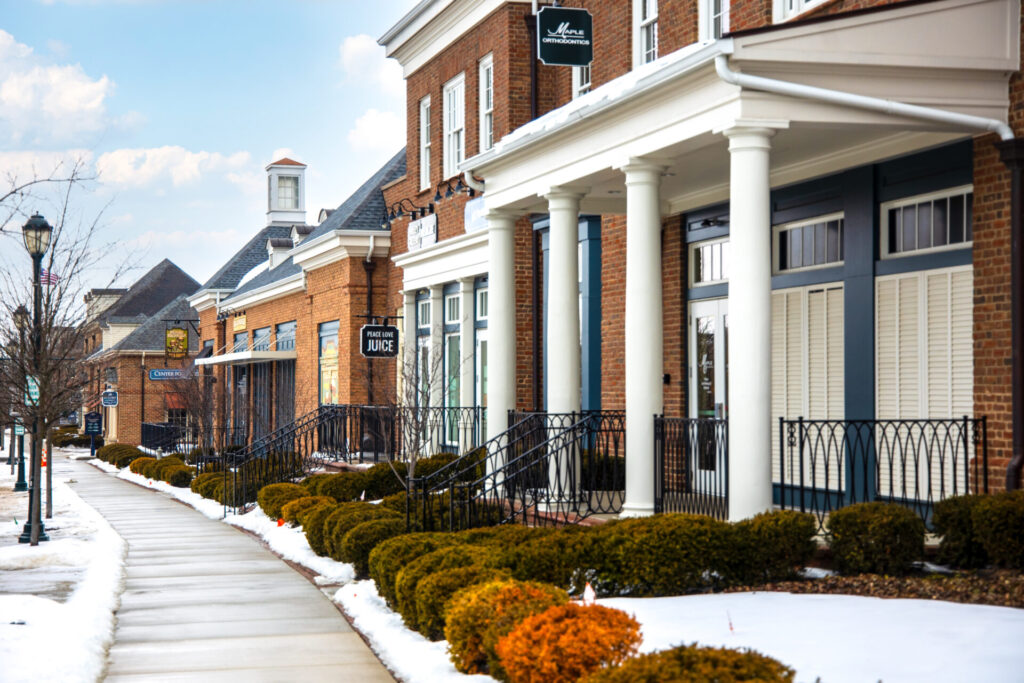 Snowy suburban street with shoveled sidewalks