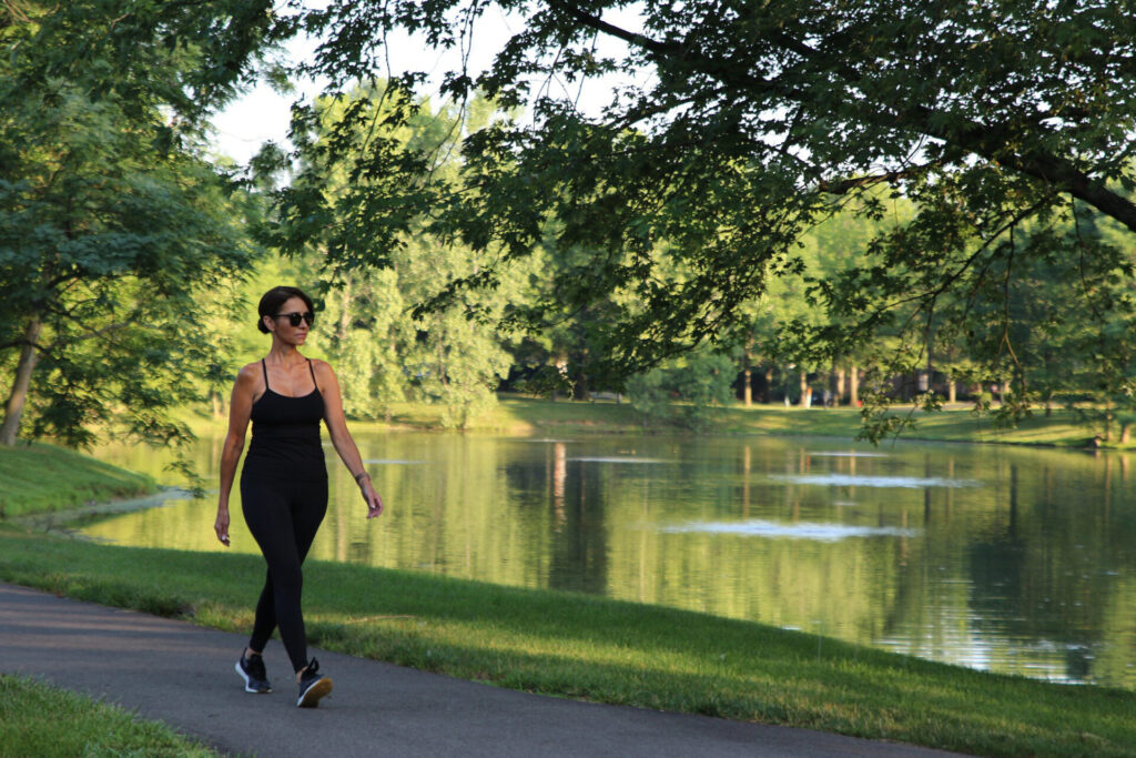 woman walking by the pond at Ratchford Fens Park