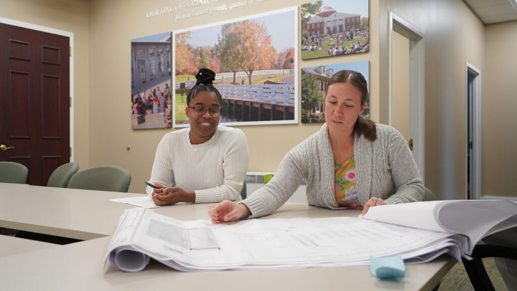 Two people reviewing plans