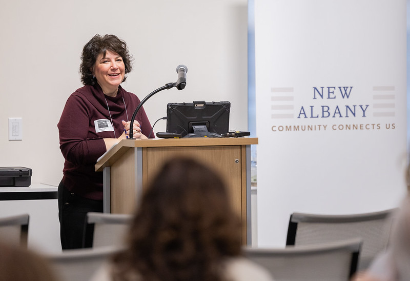 a city employee speaks from a podium