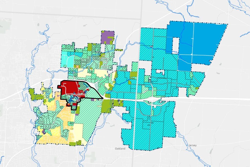 A colorful zoning map with various regions marked in different colors including red, blue, green, and yellow, displaying land use areas and thoroughfares.