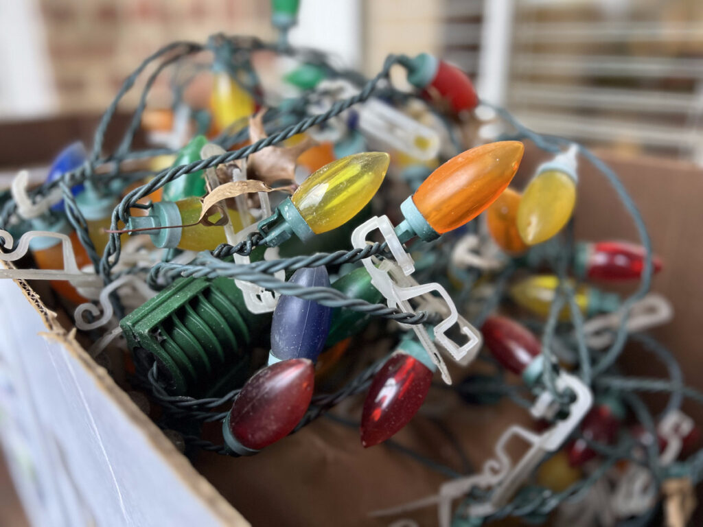 A box filled with tangled multicolored C9 Christmas lights.