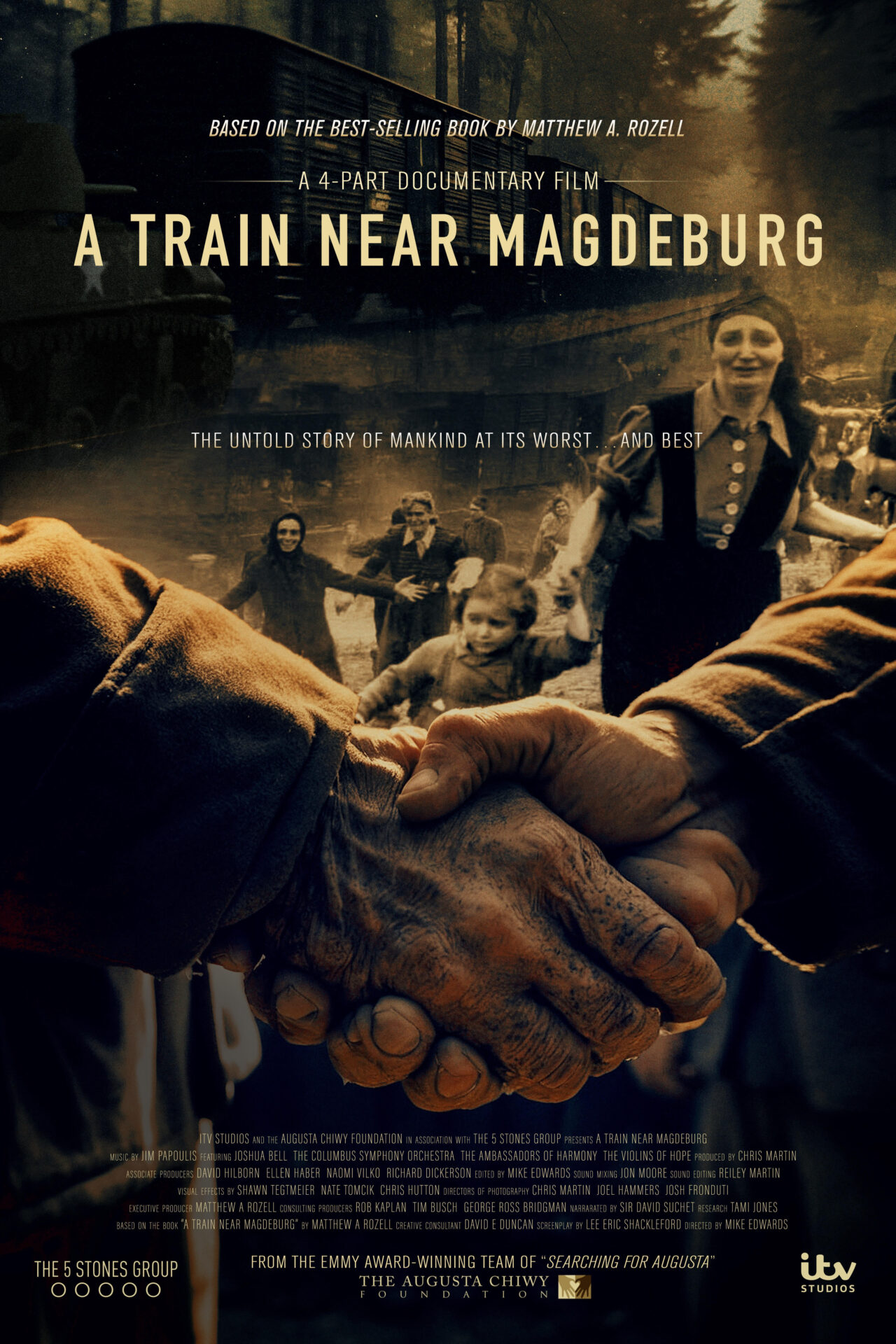 Documentary film poster showing two dirty hands clasped tightly in the foreground with blurred refugees, including women and children, and a train in a dark, smoky background, titled 'A Train Near Magdeburg' with credits overlayed.