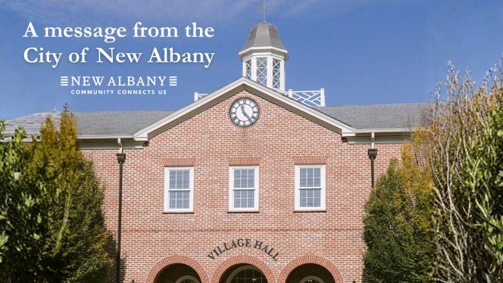 Brick Village Hall with a central clock in the gable and a small cupola, three second-floor windows above three arched ground-floor entrances, framed by evergreen trees under a clear blue sky and overlaid text reading “A message from the City of New Albany” with the New Albany logo.