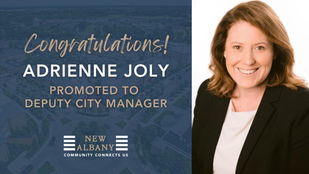 Smiling professional woman in blazer beside a New Albany announcement congratulating a promotion to deputy city manager.
