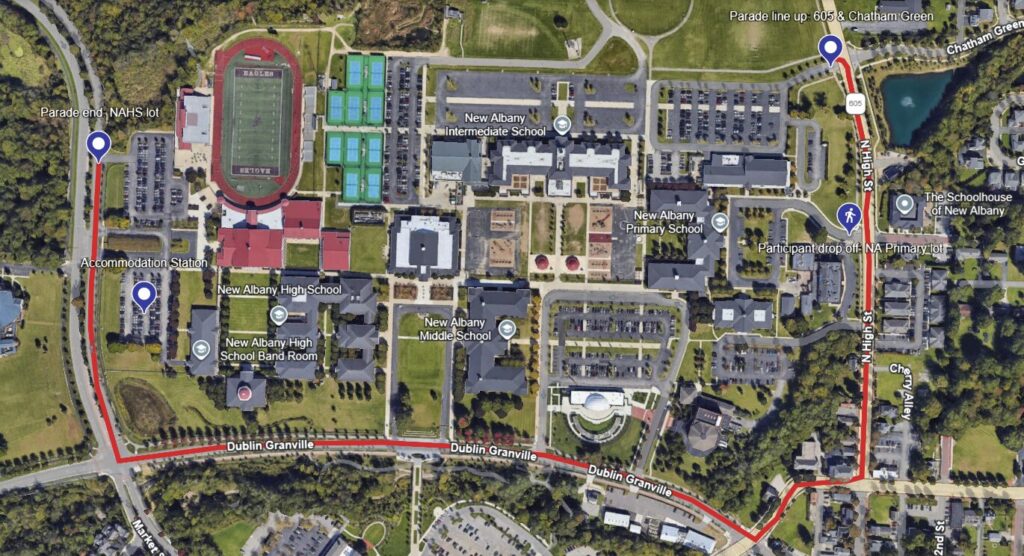 Aerial satellite view of a school campus and surrounding streets with a red parade route marked around New Albany schools.