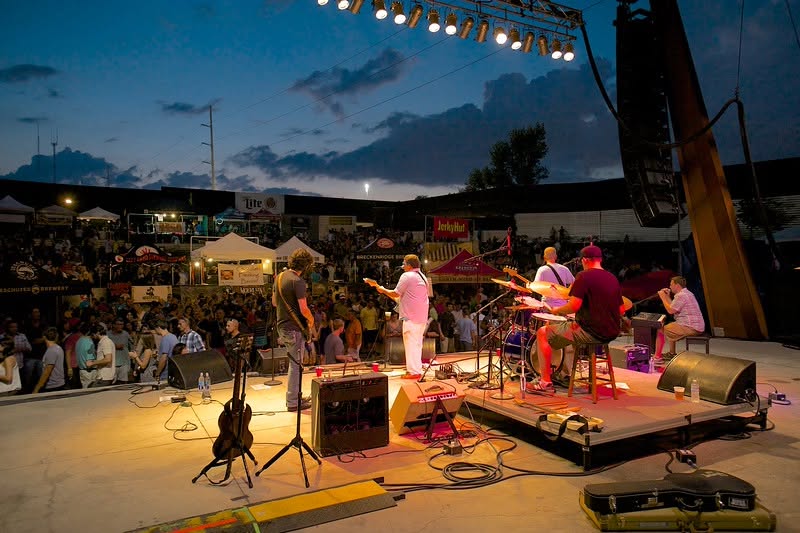 The Winnie Cooper Project band performing on a stage in front of a crowd.